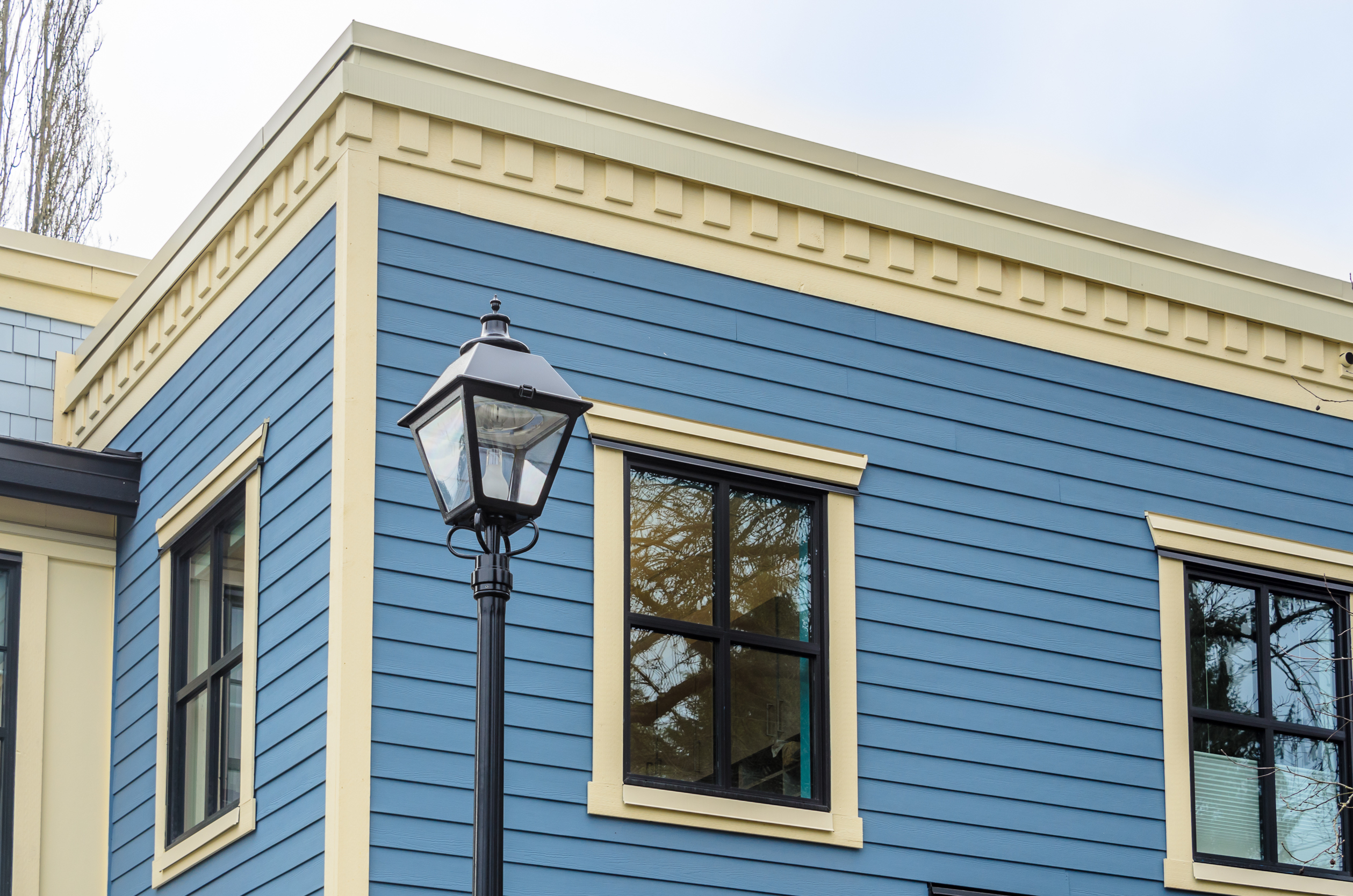 blue-building-with-black-light-post-and-windows-2026-03-26-11-23-26-utc