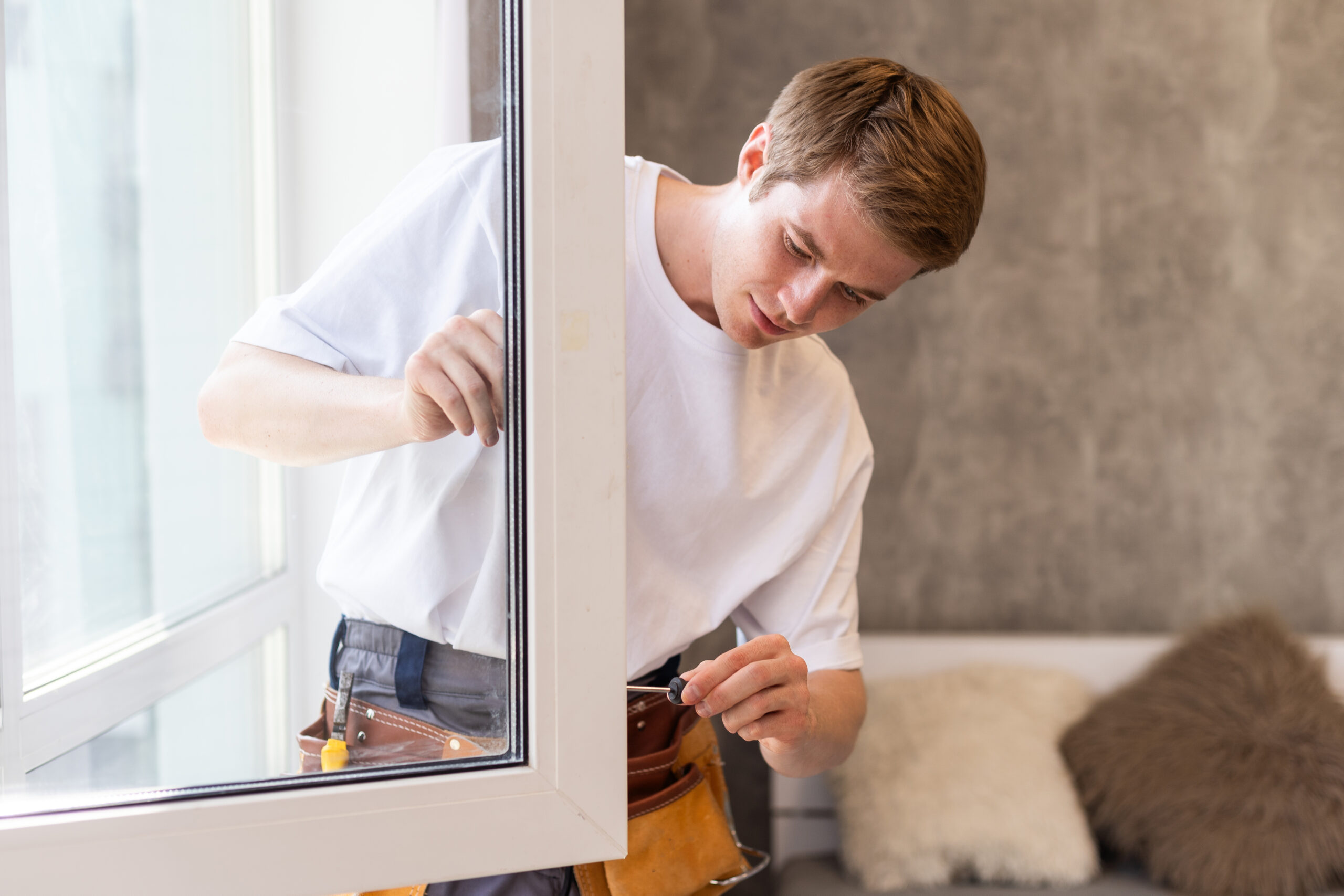 A repairman fixing windows in new apartment